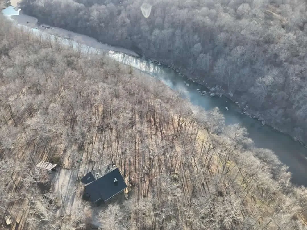 A house is seen from above in the woods.