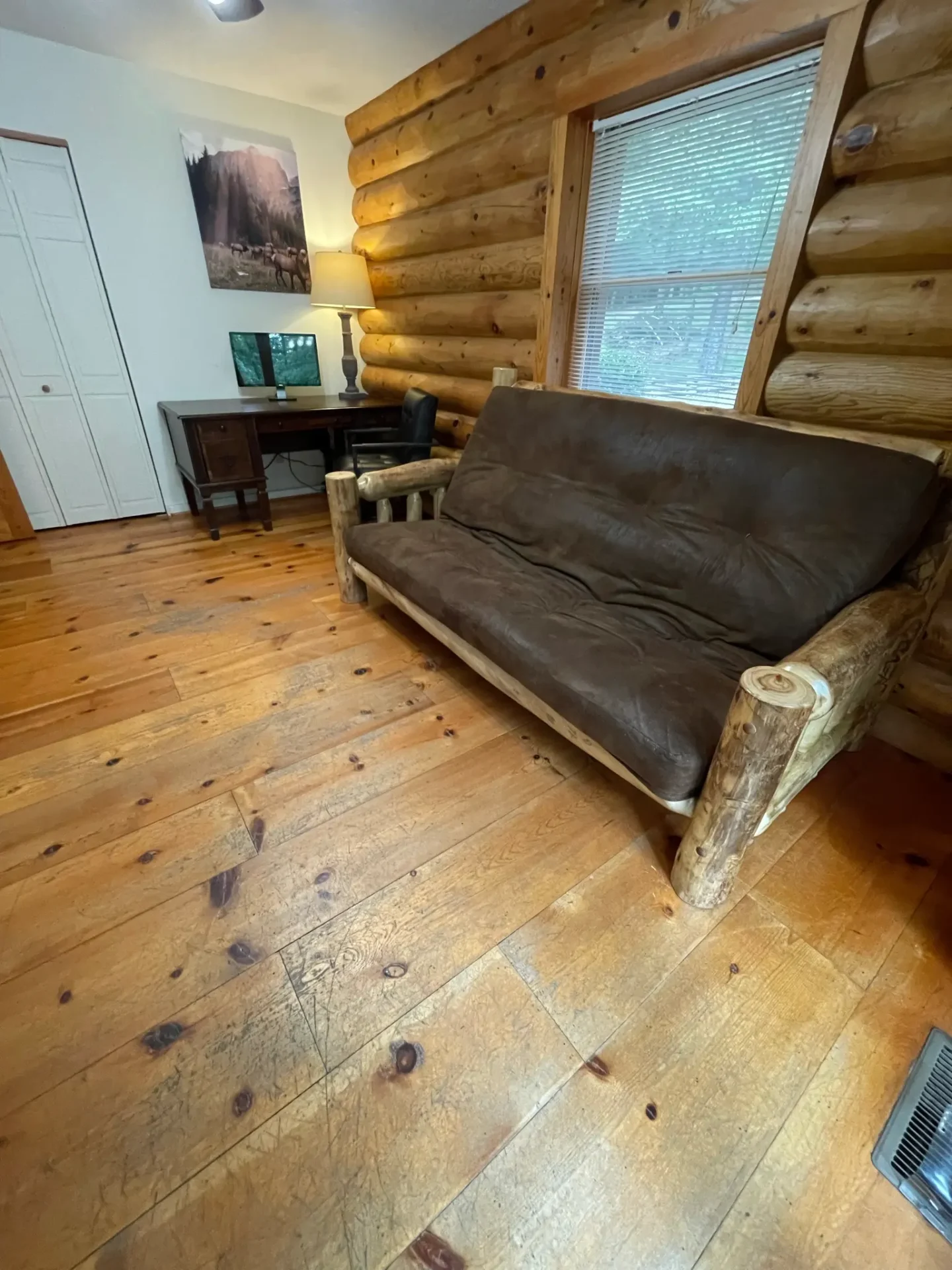 A couch in front of a window on the floor.