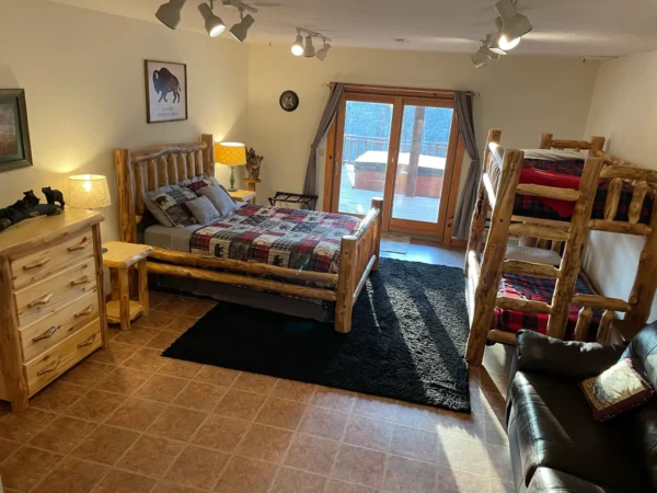 A bedroom with bunk beds and a bed in the middle.