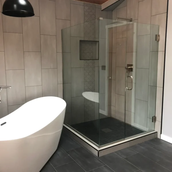 A bathroom with a tub and shower in it