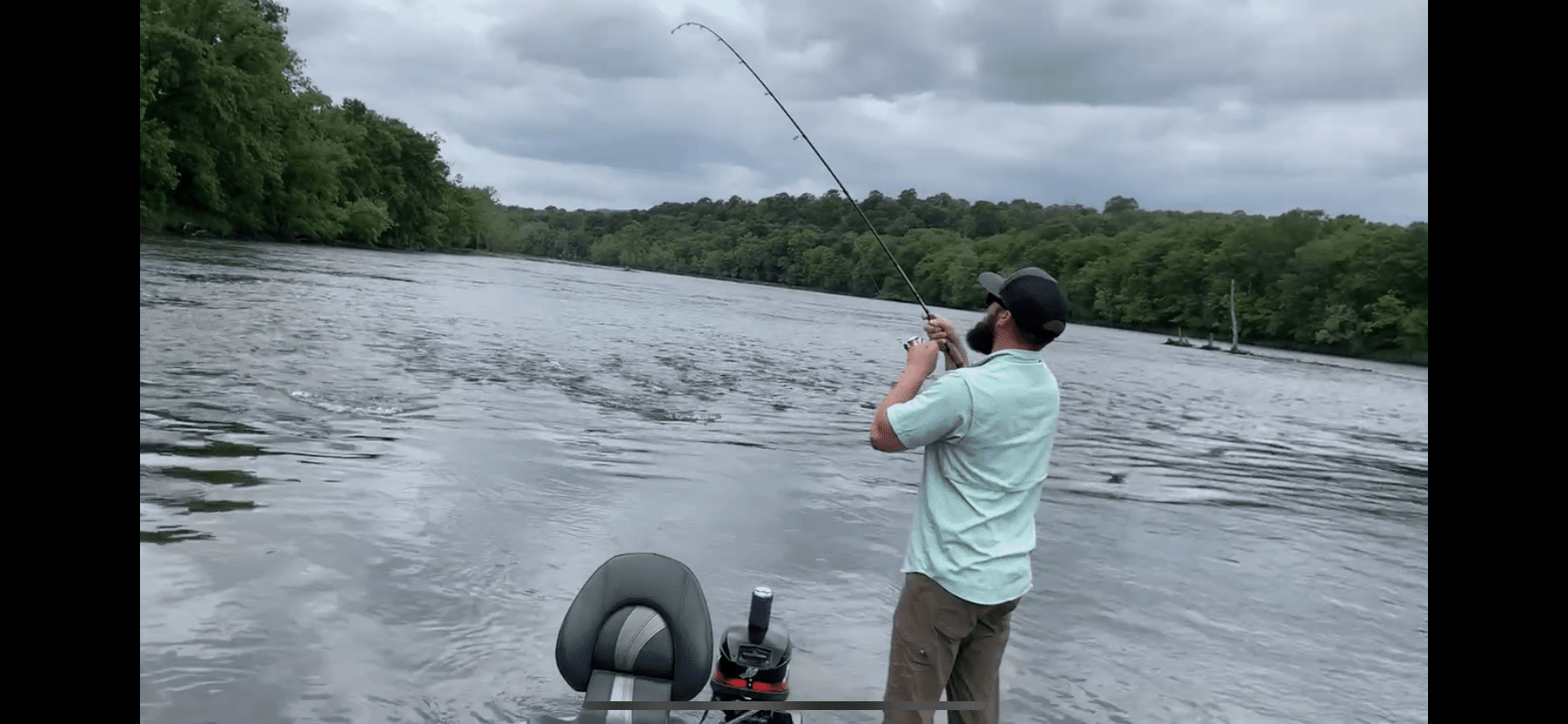 A man fishing on the water with a rod.