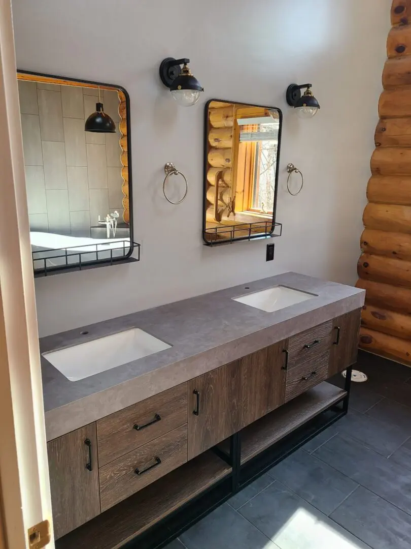 A bathroom with two sinks and mirrors in it