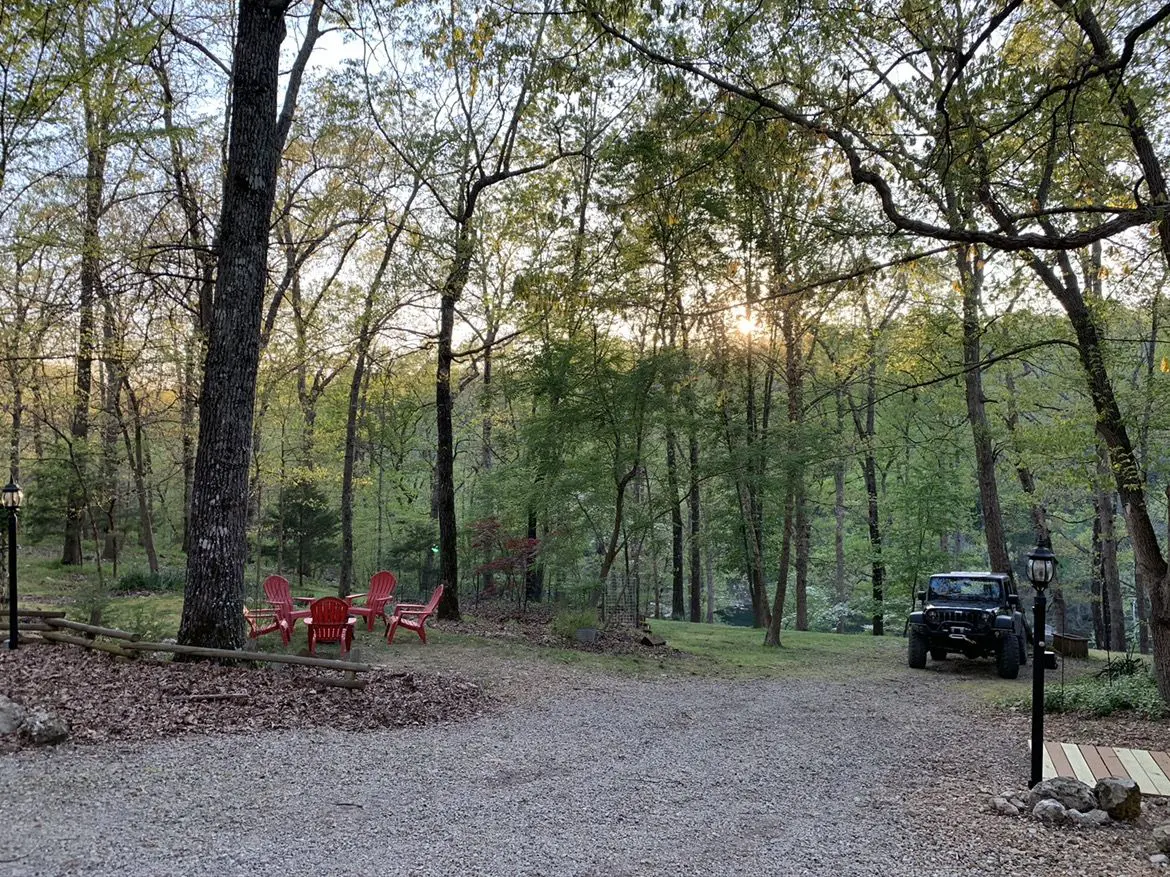 A car parked in the middle of a wooded area.