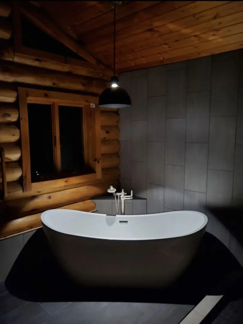 A bathroom with a tub and sink in it