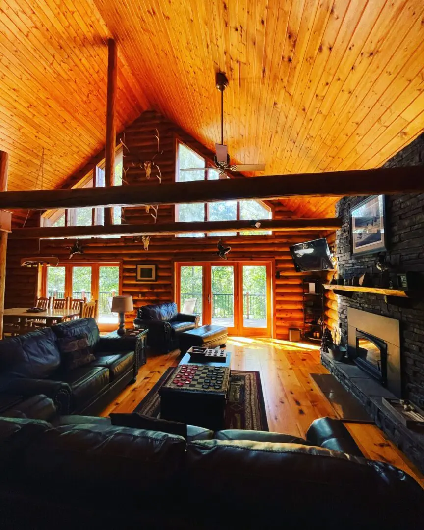 A living room with a couch, chair and fireplace.