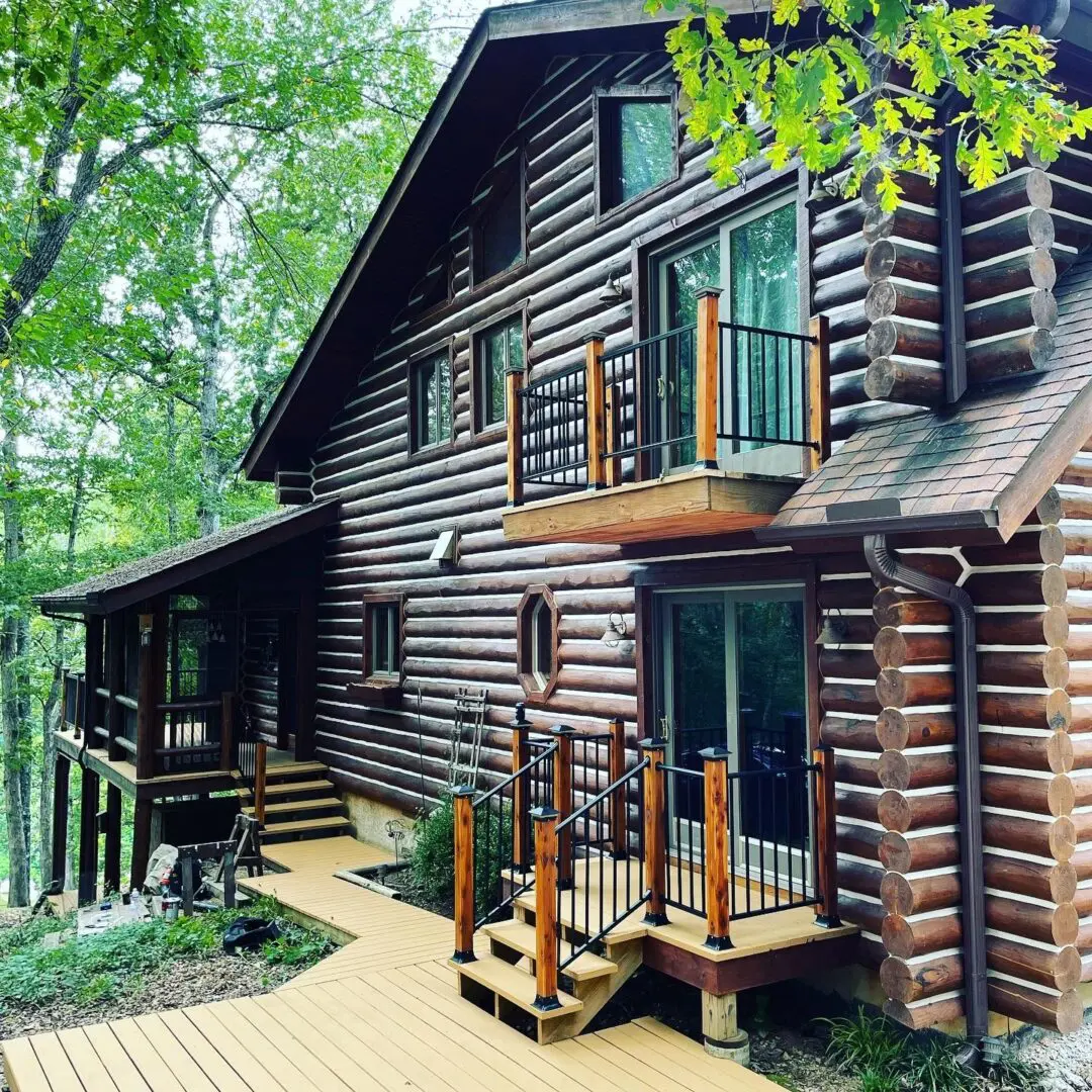 A log cabin with stairs leading to the front of it.